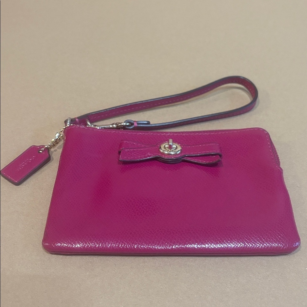 Coach wristlet with bow turn lock in cranberry